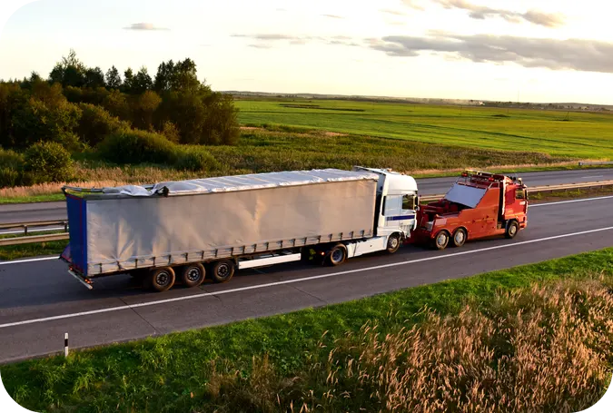 a truck towing a semi truck