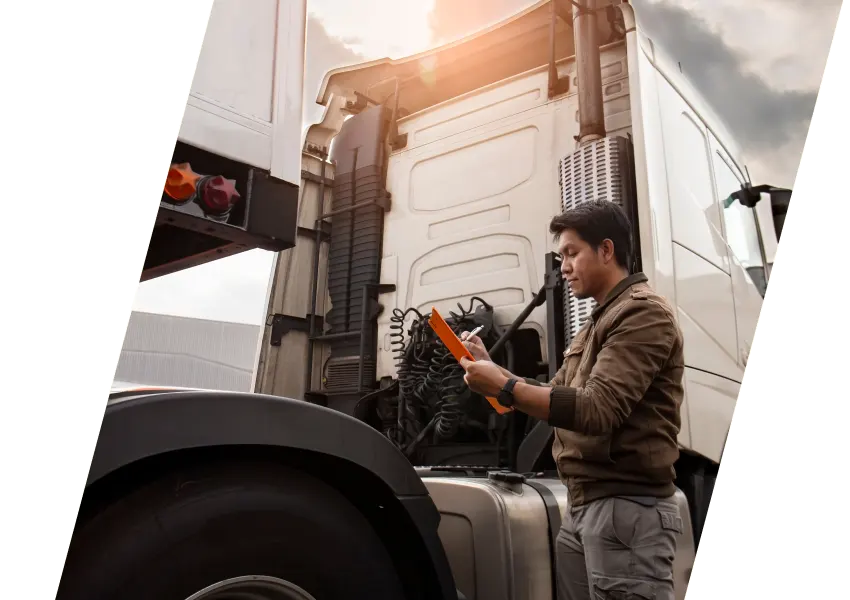 a person standing next to a truck and writing something